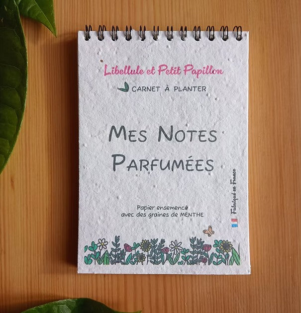 Carnet à planter  avec spirale de type bloc notes. Couverture et dos de couverture incrustés de graines de fleurs. Papier recyclé et encres vegetales. Fabriqué en France. 